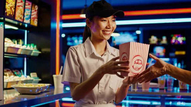 Happy Theater Attendant Serving Snacks