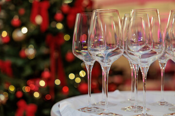 New year time party in home interior with christmas tree. empty champagne glass and desk of free space for your decoration. Winter cold day.