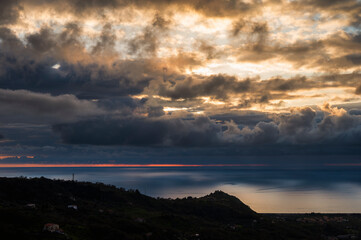 sunset over the Tyrrhenian Sea during a spring day with a cloudy sky, seen from Maierà, Cosenza