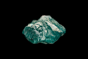 Rare natural rough uncut blue-green diamond crystal on dark background (selective focus, shallow DOF)