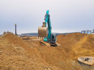 Construction site bustling with activity as a large excavator works tirelessly on earthmoving tasks...
