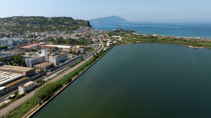 Aerial view of Fusaro Lake located in Bacoli, in the metropolitan city of Naples, Campania, Italy. It is separated from the sea by a narrow coastal strip. It was known by the Latins as Acherusia Palus