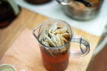 plastic pitcher filled with brewed herbal tea bags designed for soothing baths for children. Perfect for relaxation and calming bath time experiences