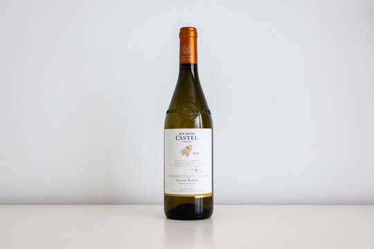 Quebec City, Quebec, Canada, January 13, 2025 - Bottle of Maison Castel Chardonnay-Viognier Grande R&eacute;serve 2023 white wine set on plain cream background