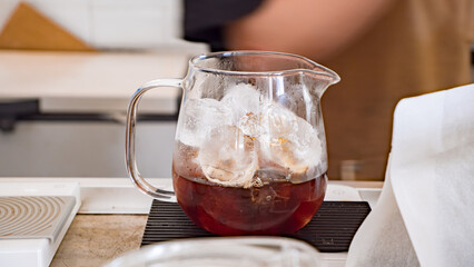 Female barista making filtered drip coffee at a coffee shop, Japanese iced coffee