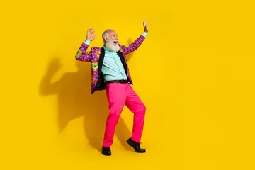 Fotobehang Full body portrait of positive grandfather vibrant designer outfit dance empty space isolated on yellow color background © deagreez