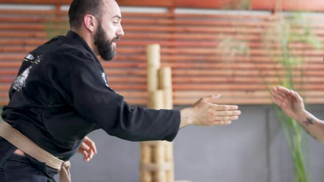Martial arts instructors practicing jiu-jitsu techniques in a dojo