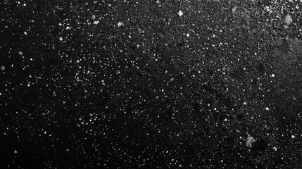 Obraz premium A mesmerizing black background with scattered white dots. A stunning texture, perfect for a winter theme.