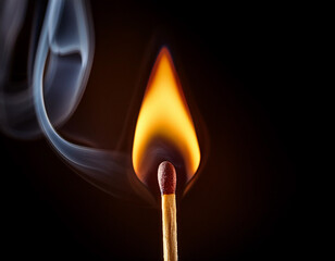 A close-up view of a lit matchstick against a dark background, capturing the subtle texture of the flame and wood.