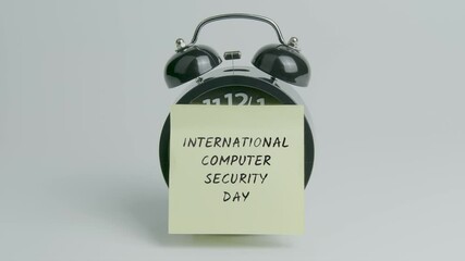 International Computer Security Day Text or Word on Yellow Note Paper Sticking onto Black Alarm Clock on White Background With Sound
