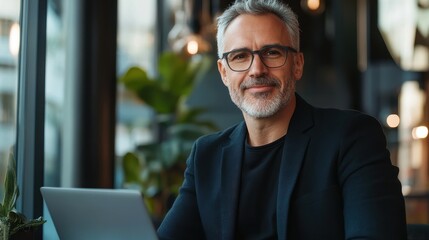 Professional man working on laptop in a modern cafe during bright afternoon hours
