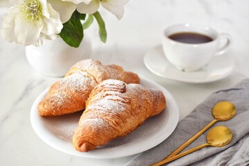 Croissants and coffee on the table. Coffee break. Croissant day.