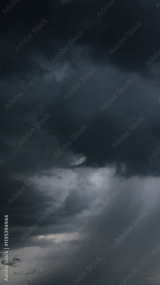 Fototapete a dark, stormy sky with heavy clouds and streaks of rain indicates bad weather and an approaching wi