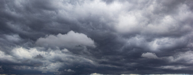 A dark and ominous sky filled with heavy clouds suggests bad weather approaching, symbolizing stormy conditions, atmospheric tension, and the unpredictable nature of the night.