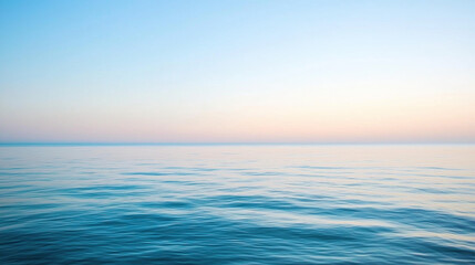 Obraz premium Serene ocean view at dawn with calm waters and soft pastel sky hues