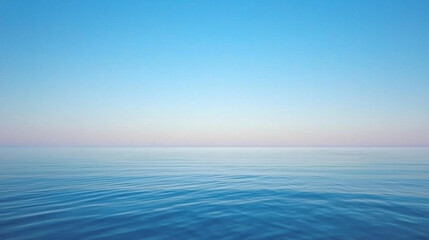 Obraz premium Serene ocean view with calm waters and clear blue sky at sunset