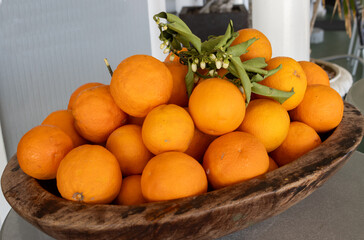 Oval wooden bowl with fresh oranges, Italy