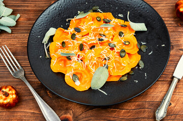 Golden pumpkin ravioli with herbs.