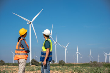 Japanese wind turbine engineer man with female Asian technician working in wind power field © Jack Tamrong