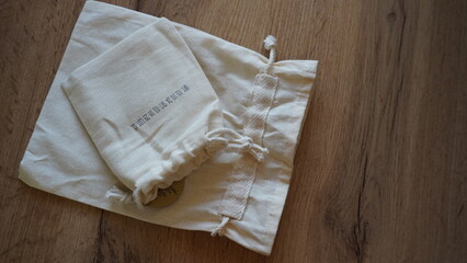 White fabric eco bags on wooden background