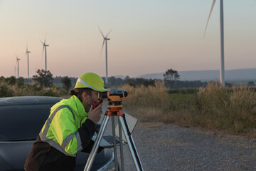 Survey Team Alternative energy for future. Engineers survey and checking wind turbines in sunset. Wind Turbine Renewable energy technology and sustainability.