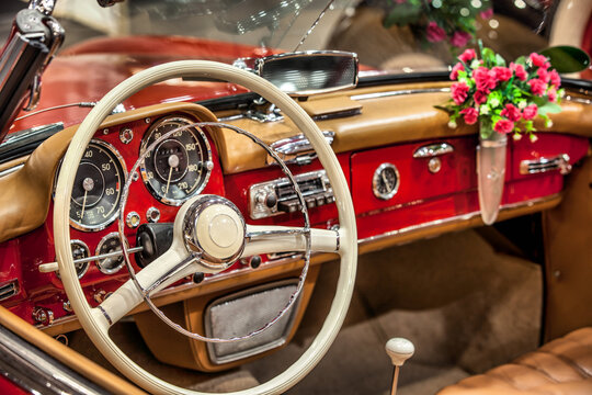 Fototapeta Vintage car interior. Retro styled image of a classic car.