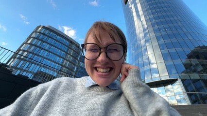 Happy successful young woman office worker or university student outdoors celebrating success