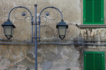 Guardiaregia - Molise - In the foreground an ancient street lamp and in the background the facade of an ancient building