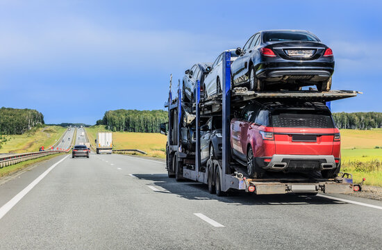 car transporter truck transports cars along a country road