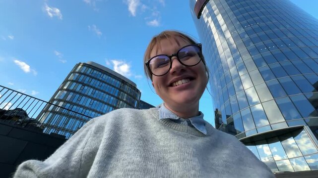 Happy successful young woman office worker or university student outdoors celebrating success