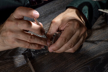 Watchmaker repairing watches looking through magnifying glass monocular. Professional senior watch fixer in repair services workshop.
