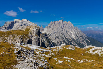 Dolomites rocky summits in the Alps. High tower peaks and sharp mountain rocky peaks of the Alps in the Dolomiti region, Italy. Beautiful scenic mountain range landscape in summer