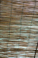 This is a detailed close up of a bamboo blind situated on a window