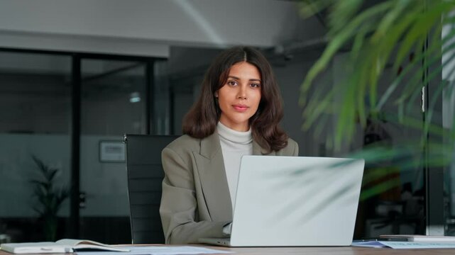 Middle age European business woman CEO using laptop application for work at table workspace in office. Smiling Latin Hispanic mature adult professional businesswoman using pc digital computer. Banner