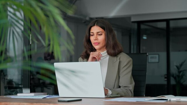 Middle age European business woman CEO using laptop application for work at table workspace in office. Smiling Latin Hispanic mature adult professional businesswoman using pc digital computer. Banner