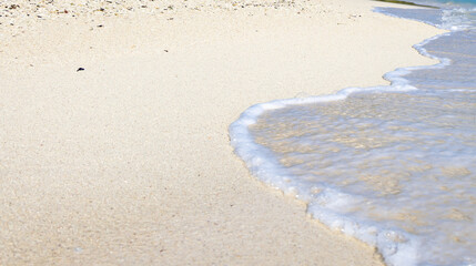 Sea Waves white foam Rolling Over Sandy Beach Shore at Morning