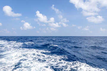 splash of ship water trails cutting through calm sea