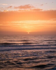 Fototapeta premium Sunrise over waves in the Atlantic Ocean in St. Augustine Beach, Florida