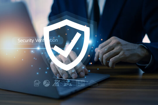 Businessman conducts a security verification process on his computer, safeguarding corporate information from cyber threats and potential breaches