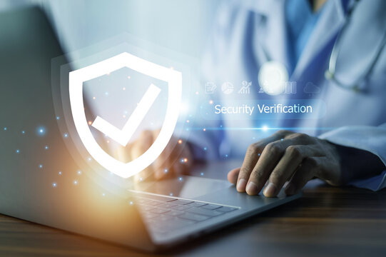 Doctor performs security verification on a laptop, ensuring secure access to sensitive medical data and maintaining patient confidentiality. - Powered by Adobe
