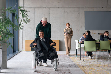 Obraz premium A diverse team of business colleagues, including a director in a wheelchair, engages in a collaborative discussion as they move together through a modern office space
