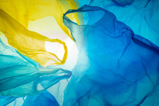 colorful disposable plastic bags background, crinkled and jumbled structure, plastic waste pollution 