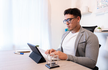 Young entrepreneur concepts. Businessman sitting at desk in modern office