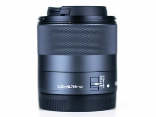 Close-up of a black camera lens on a white background