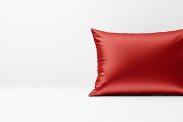 A vibrant red pillow rests against a minimalist white background, showcasing a modern and stylish aesthetic.