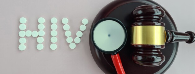 Judicial gavel and text hiv aids and stethoscope AIDS fight symbol