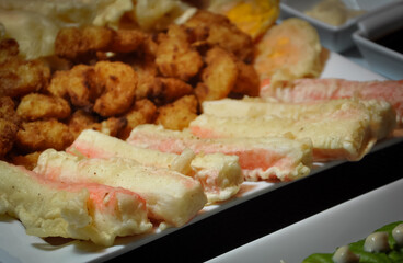 Fried food like fried crab meat tempura and fried shrimp on the table