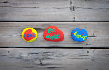 Colourful painted rocks with be kind and love text on it