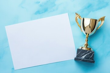 Golden trophy and blank paper on blue background