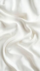 Naklejka premium Soft white silk fabric with gentle folds creating a smooth and elegant texture